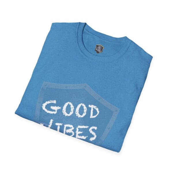 Folded blue T-shirt featuring a partial design of the "Good Vibes Only" shield on the front.