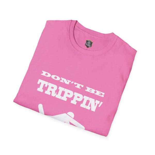 Don't Be Trippin'" T-Shirt in pink, featuring an illustration of a person falling.