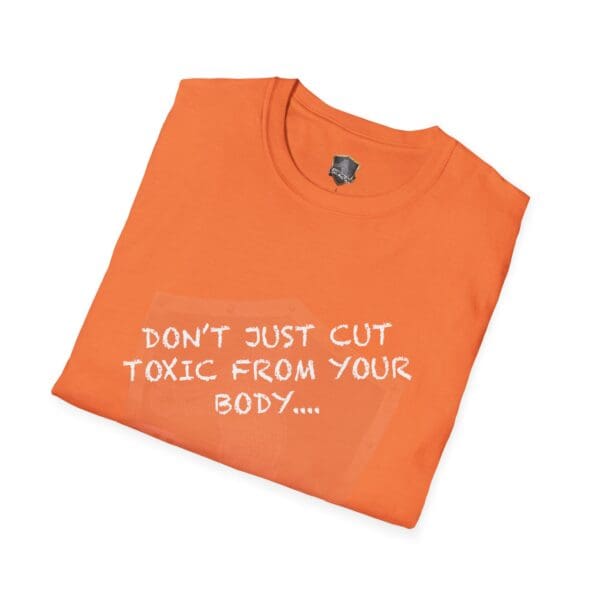 A neatly folded orange t-shirt displaying the white text, "Don't Just Cut Toxic from Your Body, Cut It from Your Life!