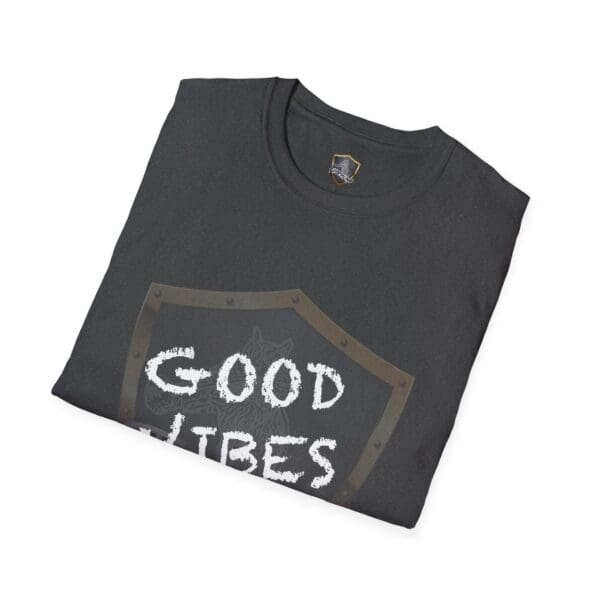 Black folded t-shirt with a shield design displaying "GOOD VIBES" in white, known as the Good Vibes Only Shirt.