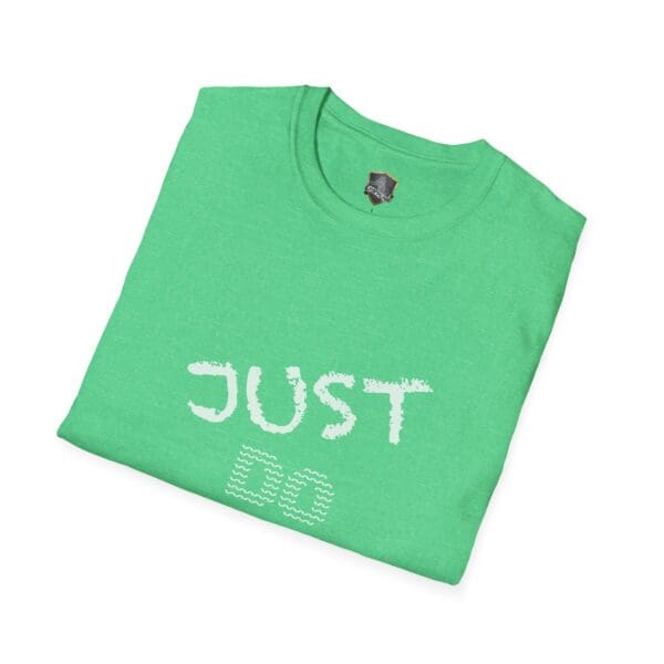 A folded green t-shirt printed with "Just Do Your Job!" on the front in a casual font.