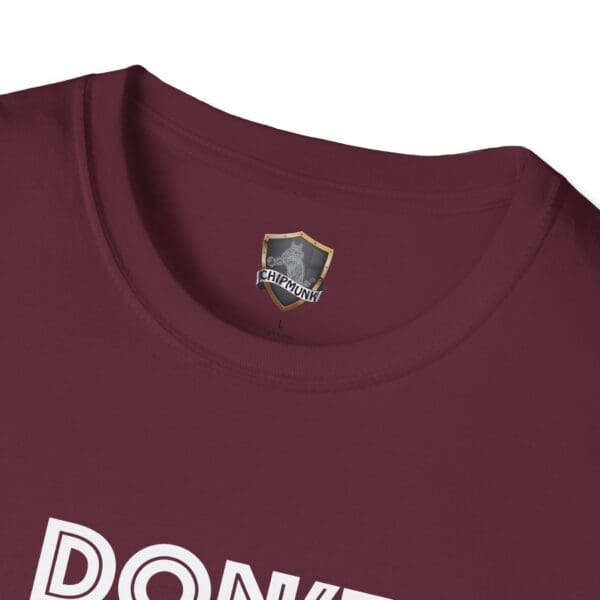 Close-up view of a maroon T-shirt collar with a "CHIPMUNK" label and partial white text "DON'T BE A..." visible below.