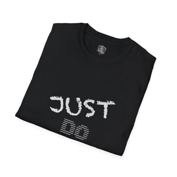 A folded black "Just Do Your Job!" t-shirt with the text "JUST DO" in stylized white letters on the front.