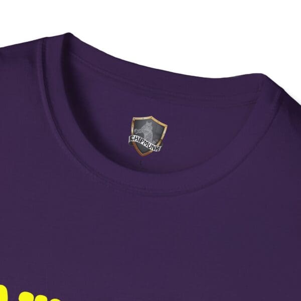 A close-up of the Awesome Shirt, featuring a purple t-shirt design with a "CHIPMUNK" shield logo prominently displayed inside the collar area and partially visible yellow text below.