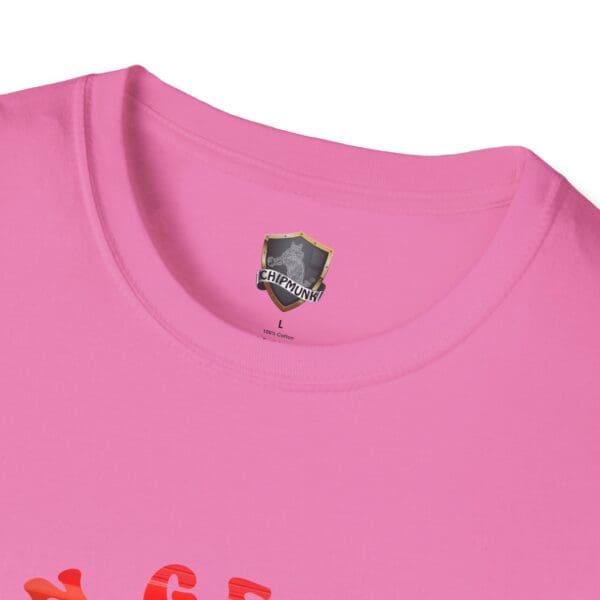 Close-up of a pink T-shirt showing the collar and a black and white label with "C'mon George!!" printed on it.