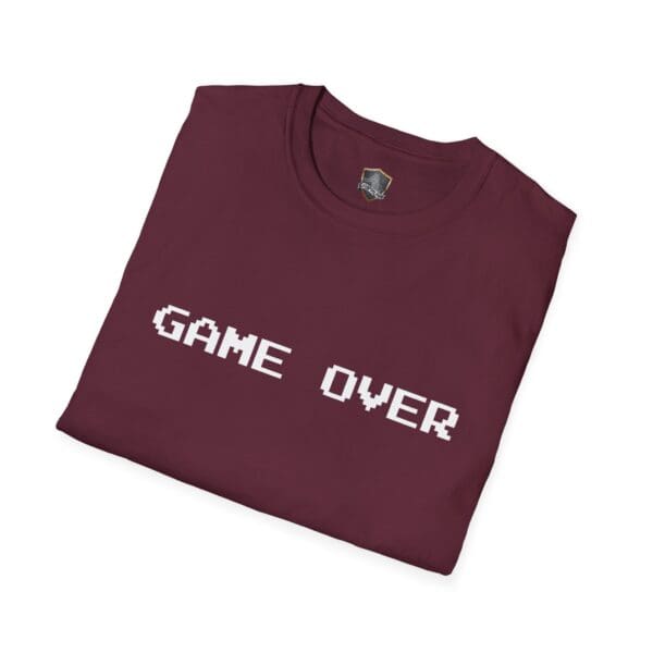 A folded maroon Game Over T-Shirt featuring "GAME OVER" in white pixelated text on the front.