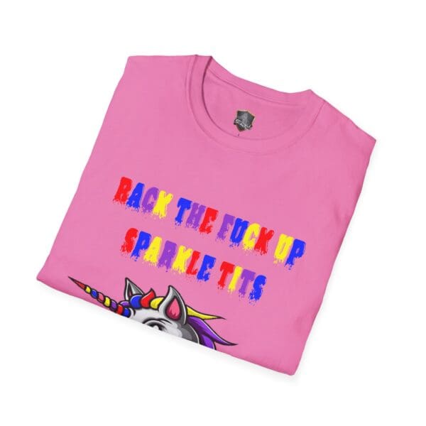 A folded pink T-shirt featuring a vibrant unicorn design and bold text stating "BACK THE F**K UP SPARKLE TITS," known as the Colorful Angry Unicorn Tee.