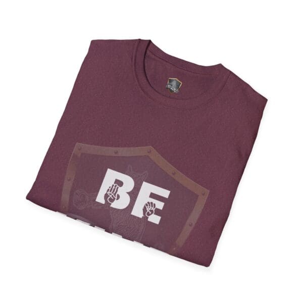 A folded maroon Be Kind in Sign Language T-shirt featuring "BE" and two hand symbols on the front.