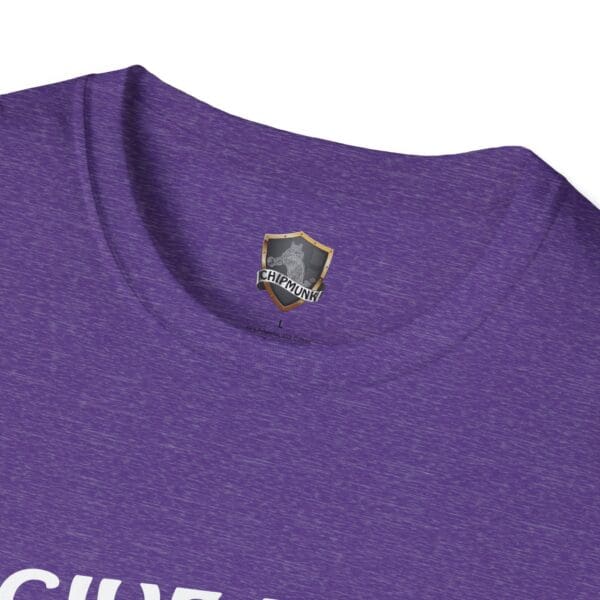 Close-up of a purple "Give Me The Tips" T-shirt collar featuring a shield-shaped tag labeled "Chipmunk" with a chipmunk logo above.