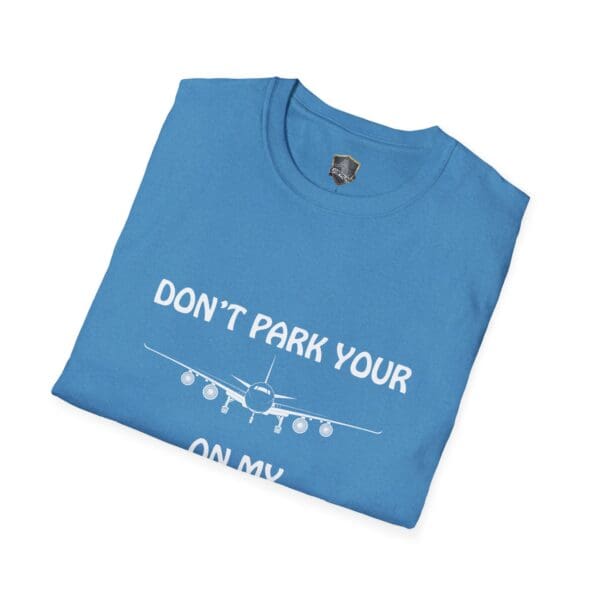 Blue folded T-shirt displaying white text and an airplane graphic, with the message, "DON'T PARK YOUR PLANE ON MY DINGY.