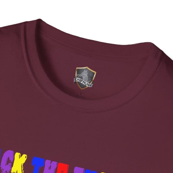 Close-up of a maroon tee with a colorful graphic partially visible and a label inside the collar reading "Colorful Angry Unicorn Tee.