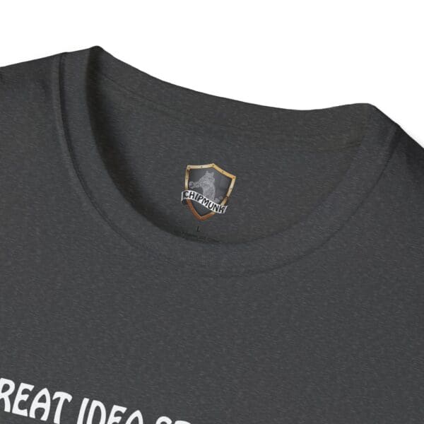 Close-up of the neckline of a dark gray Great Idea T-Shirt, featuring a small chest emblem with a shield and the word "Chipmunk." Partial view of white text below.