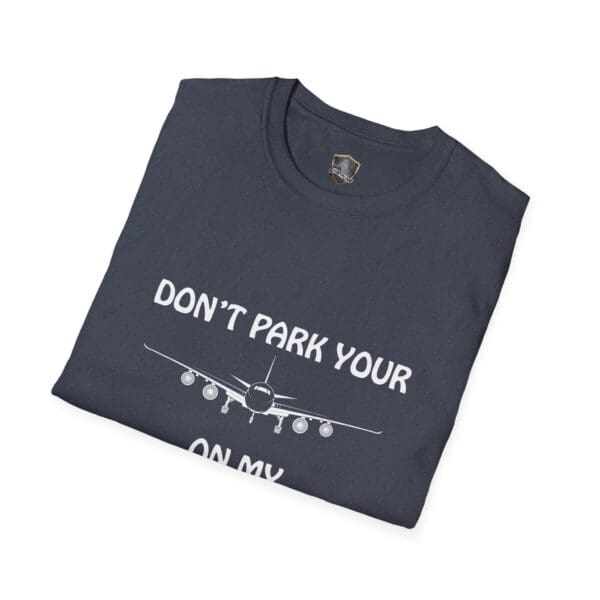 Folded dark t-shirt featuring a graphic of an airplane and the text: "Don't Park Your Plane On My Dingy.