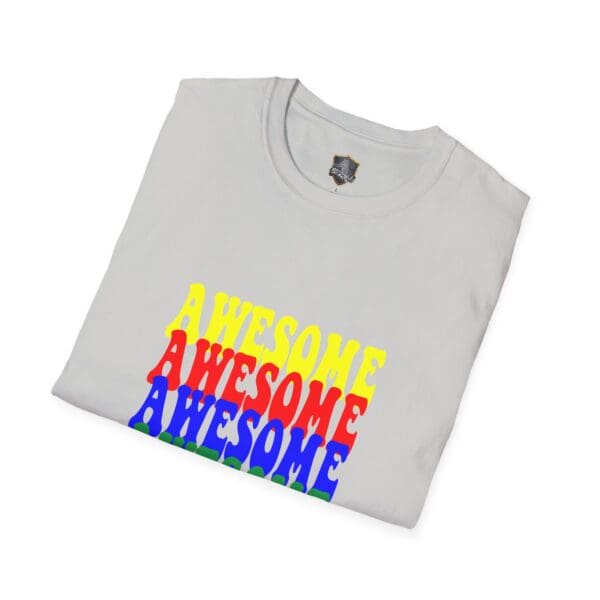 A folded white Awesome Shirt featuring the word "AWESOME" printed three times in yellow, red, and blue.