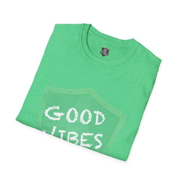 A folded green Good Vibes Only Shirt with a partial graphic.