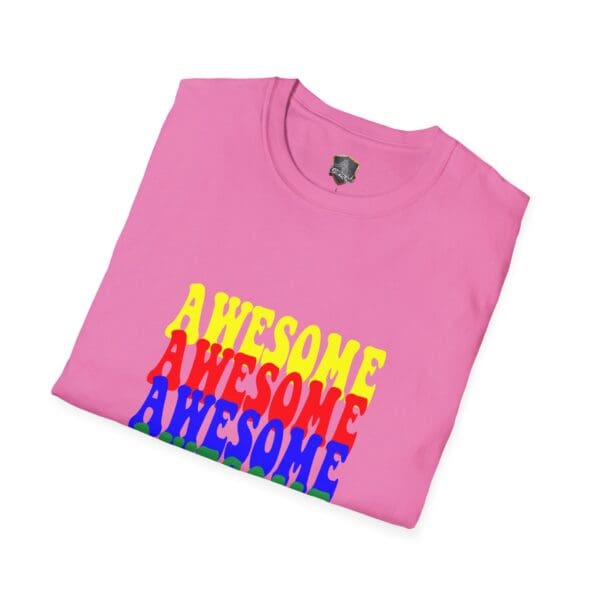 A folded Awesome Shirt in pink with "AWESOME" printed three times on the front in yellow, red, and blue.