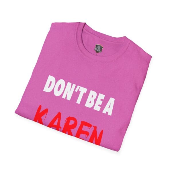 Folded pink t-shirt featuring the phrase "DON'T BE A KAREN" in bold letters.