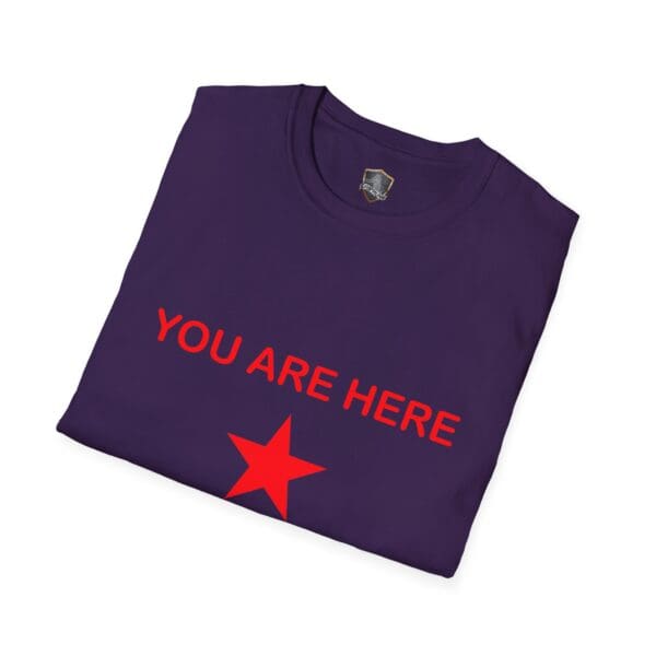 A folded black Guiding Star Tee Shirt displays "YOU ARE HERE" in red text above a red star.