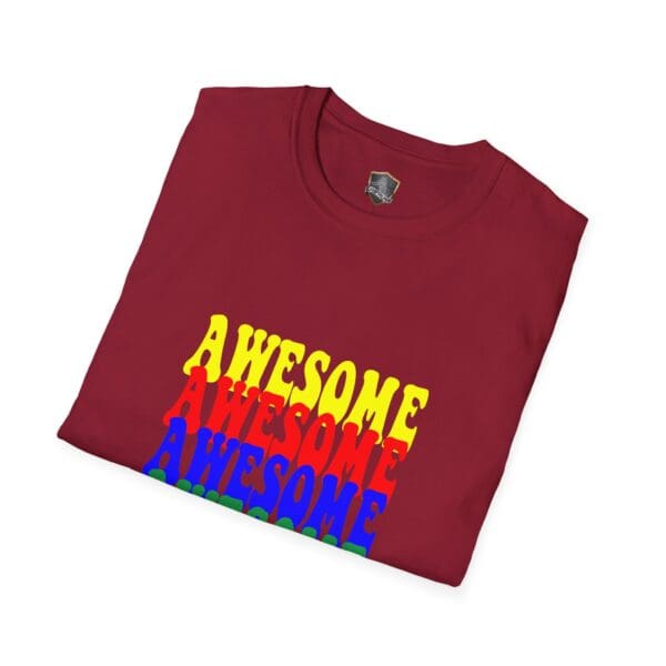 A folded maroon Awesome Shirt featuring the word "AWESOME" printed in a vibrant gradient of yellow, red, and blue on the front.