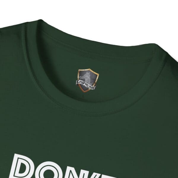 Close-up of the neckline of a green "Don't Be A... Tee," showcasing the Chipmunk brand logo with a shield design on the collar.