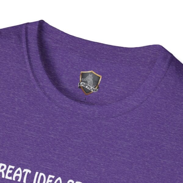 Close-up of the Great Idea T-Shirt in purple, featuring a small shield logo near the neckline and partially visible text at the bottom.