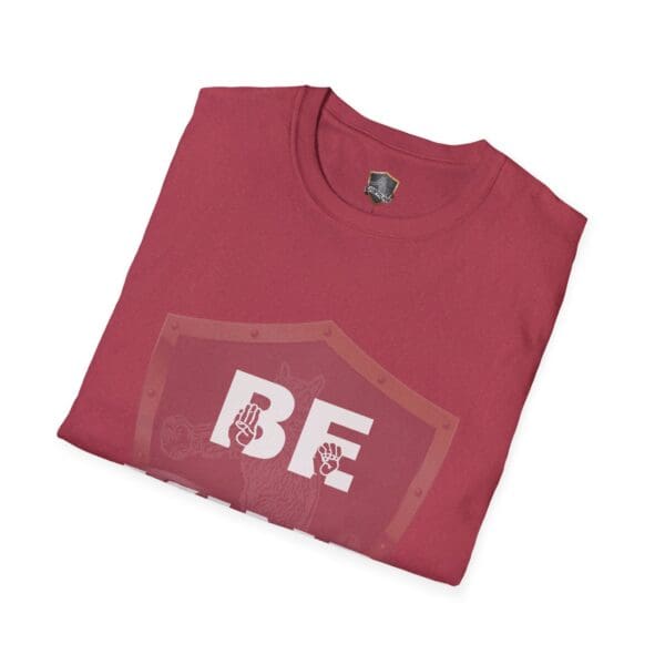 Folded maroon t-shirt showcasing the "Be Kind in Sign Language" design with a shield graphic, "BE" text, and two small hand illustrations.