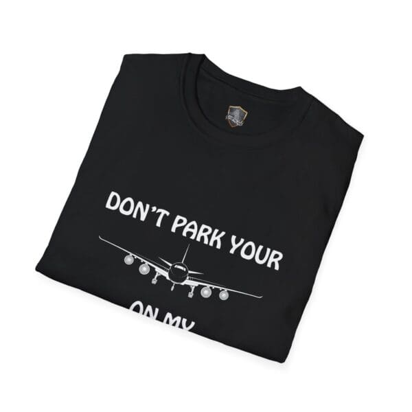 Folded black t-shirt featuring a graphic of an airplane and the text "DON'T PARK YOUR PLANE ON MY DINGY.