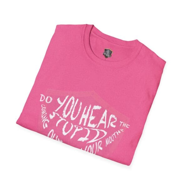 A folded "Hear The Stupid" T-shirt in pink with white text.