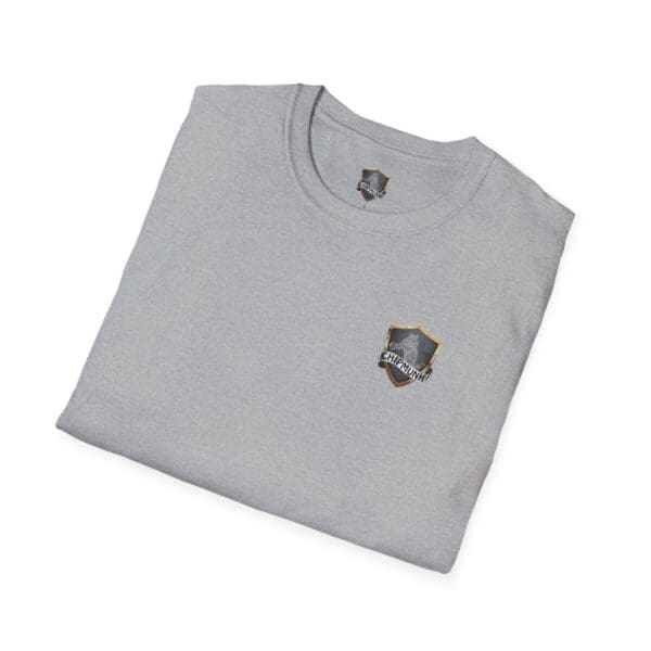 Neatly folded Kick Me T-Shirt in gray, featuring a small logo of a shield and feather on the chest.