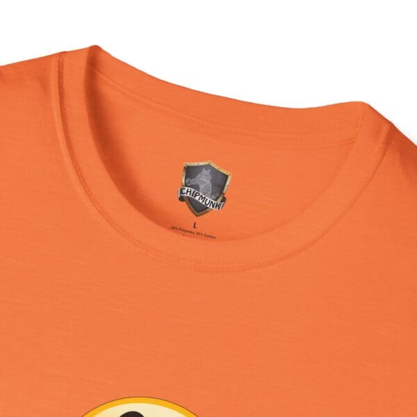 Close-up of an orange *No One Cares* T-shirt featuring a small emblem near the collar that reads "Chipmunk" above a smiley face design.