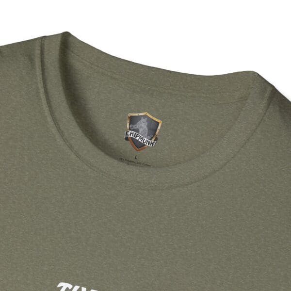 Close-up of The Man T-Shirt in green featuring a Chipmunk brand label inside the collar, displaying a logo and size "L" information.