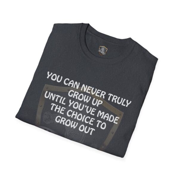 A folded black 'You Can Never Truly Grow Up T-Shirt' with the text "You can never truly grow up until you've made the choice to grow out" printed on the front.