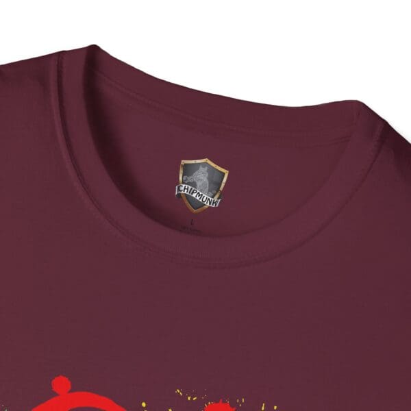 Close-up of a maroon collar on the Splash Chipmunk T-Shirt, featuring a label with a shield logo and the brand name "Chipmunk." The shirt showcases a partially visible red and yellow graphic design.