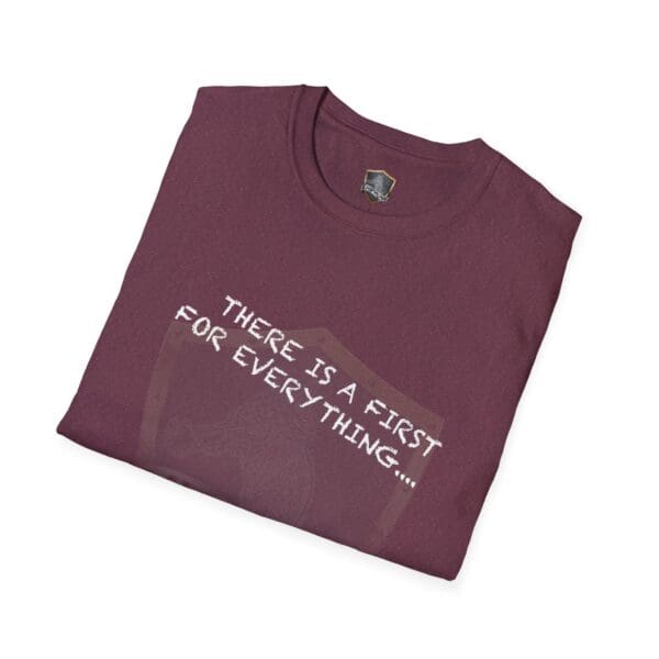 Folded maroon t-shirt displaying white text that says, "There's a First for Everything... Except Impressions!" with a subtle design in the background.