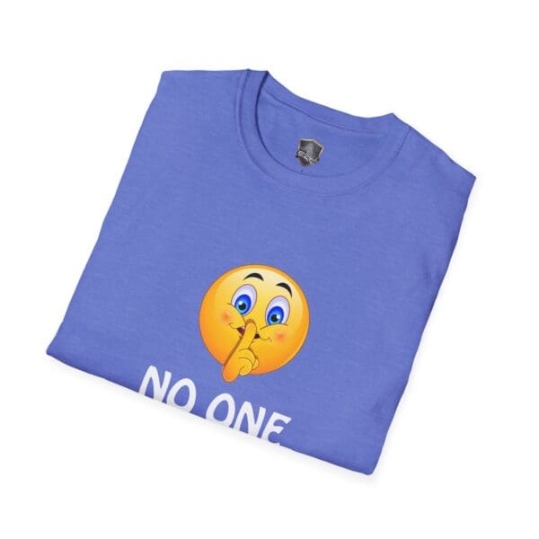 Folded blue T-shirt featuring a shushing emoji and partially visible text "NO ONE" from the No One Cares T-Shirt collection.