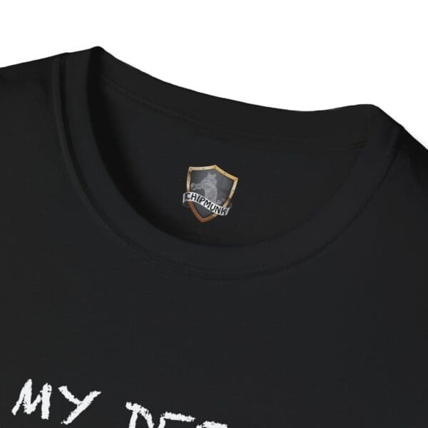 Close-up of a black "Unsupervised Mischief T-Shirt" featuring a "Chipmunk" logo on the inside collar.