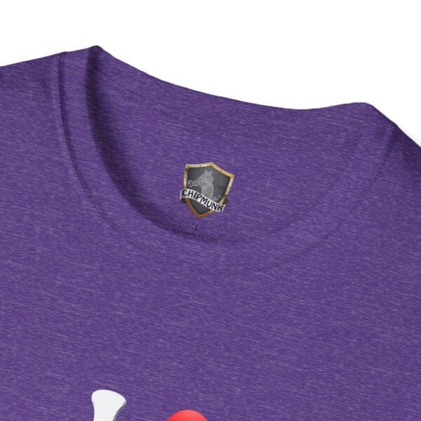 Close-up of the collar of a purple T-shirt featuring a small shield-shaped label with an "I Love Hot Taco" graphic.