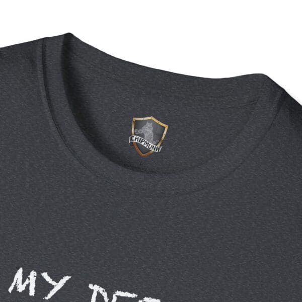 Close-up of the Unsupervised Mischief T-Shirt in dark gray, displaying a shield logo with "Chipmunk" text, and partially visible white text at the bottom.