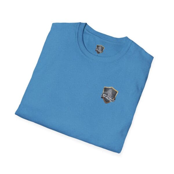 Kick Me T-Shirt in blue, featuring a small black and gold crest logo on the front and folded for display.