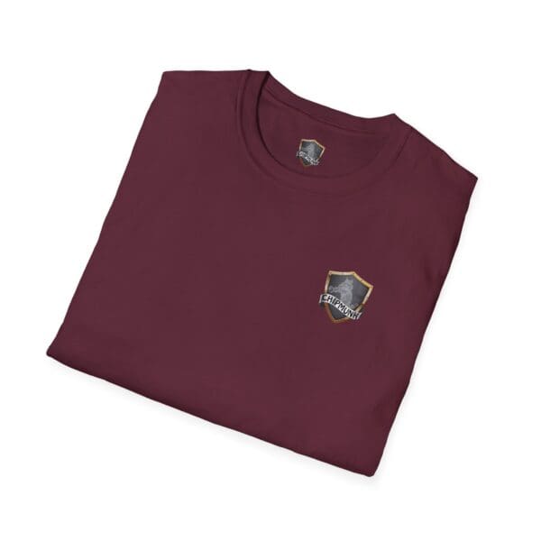 Folded Vacation T-Shirt in maroon with a small shield emblem on the front.