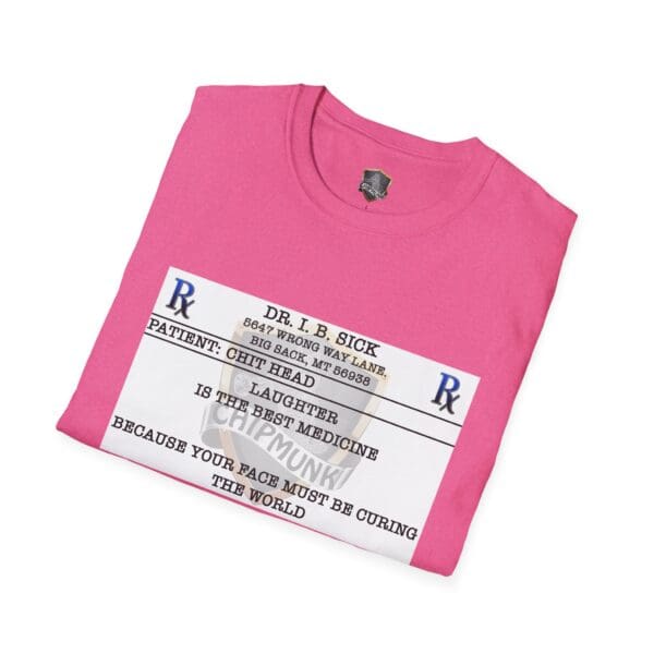 A folded Laughter T-Shirt in pink, showcasing a humorous prescription label design with a fictional address and a doctor's note claiming that laughter is the best medicine.