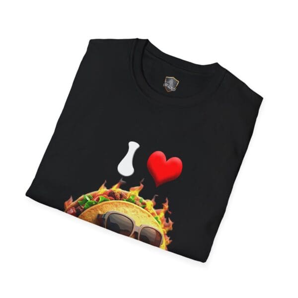 Presenting the "I Love Hot Taco T-Shirt," a folded black tee showcasing a vibrant graphic of a taco wearing sunglasses, surrounded by flames, with added elements of a white vase icon and red heart symbol.