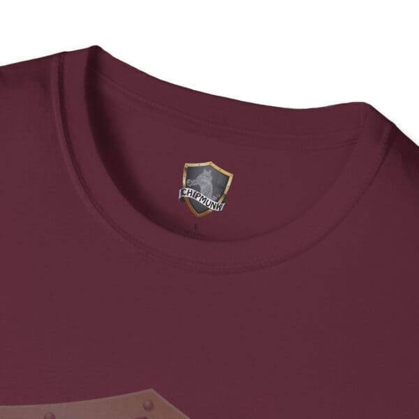 Close-up of a maroon Chipmunk Brand T-Shirt featuring a graphic shield logo and "Chipmunk" on the inner tag.