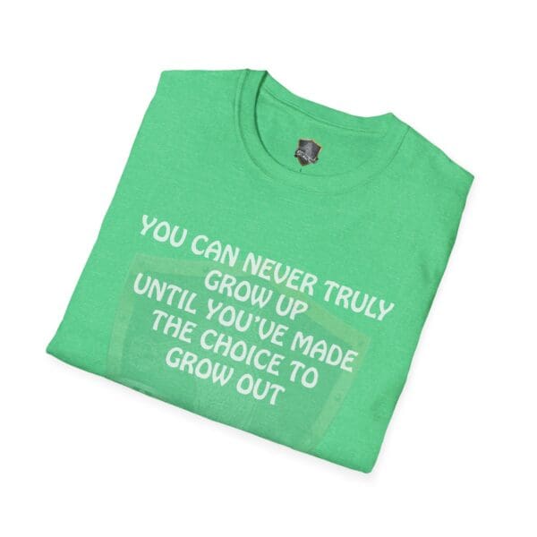 A folded green 'You Can Never Truly Grow Up T-Shirt' with the quote "You can never truly grow up until you've made the choice to grow out" printed in white.