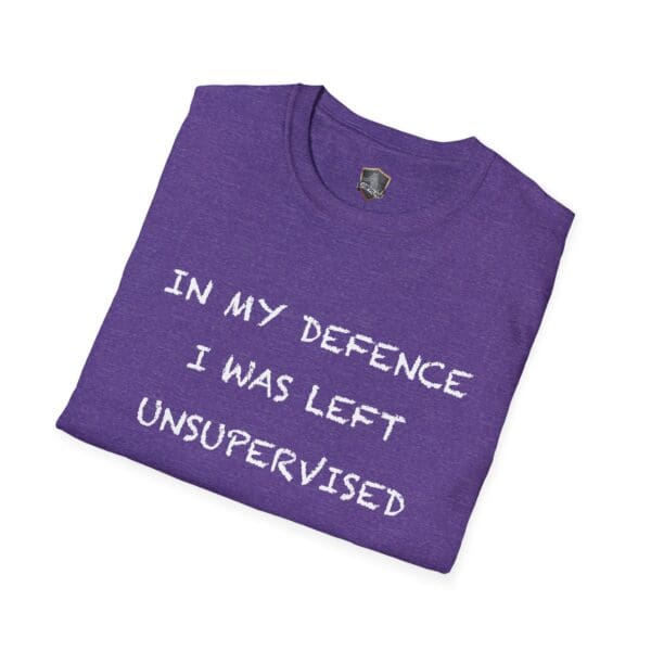 A folded purple "Unsupervised Mischief T-Shirt" with the text "IN MY DEFENCE I WAS LEFT UNSUPERVISED" printed on the front.