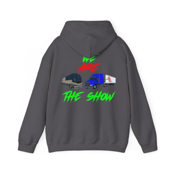 Introducing "The Show Hoodie": a gray hoodie featuring a graphic of a tour bus, truck, and white van. Above and below the vehicles, you'll find the phrase "WE ARE THE SHOW" displayed in vibrant red and green graffiti-style letters.