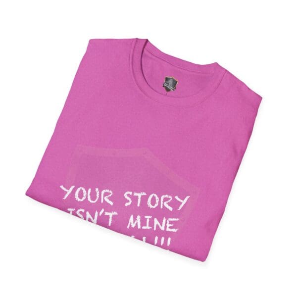 Folded pink "Your Story Is Not Mine to Tell" t-shirt with white text partially visible.