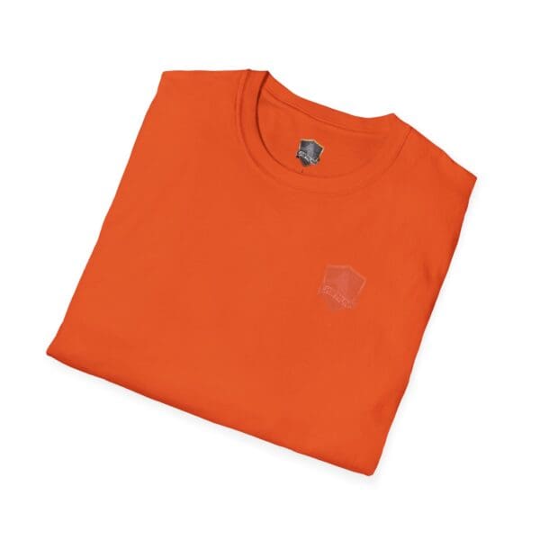 The "You Bought It Because We Brought It" T-shirt in orange, featuring a subtle logo design near the collar, is neatly folded against a white background.