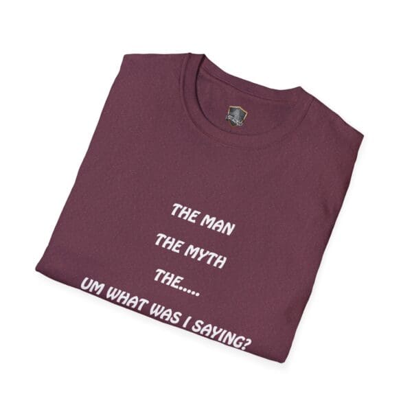 A folded maroon "The Man T-Shirt" featuring the text "THE MAN THE MYTH THE... UM WHAT WAS I SAYING?" printed in white letters on the front.