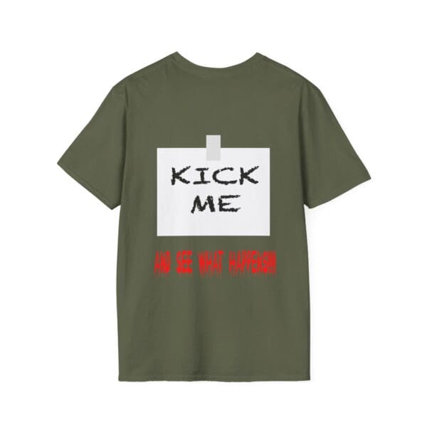 Olive green Kick Me T-Shirt featuring the text "KICK ME" in black and "AND SEE WHAT HAPPENS" in red below, styled to look like a taped note on the back.